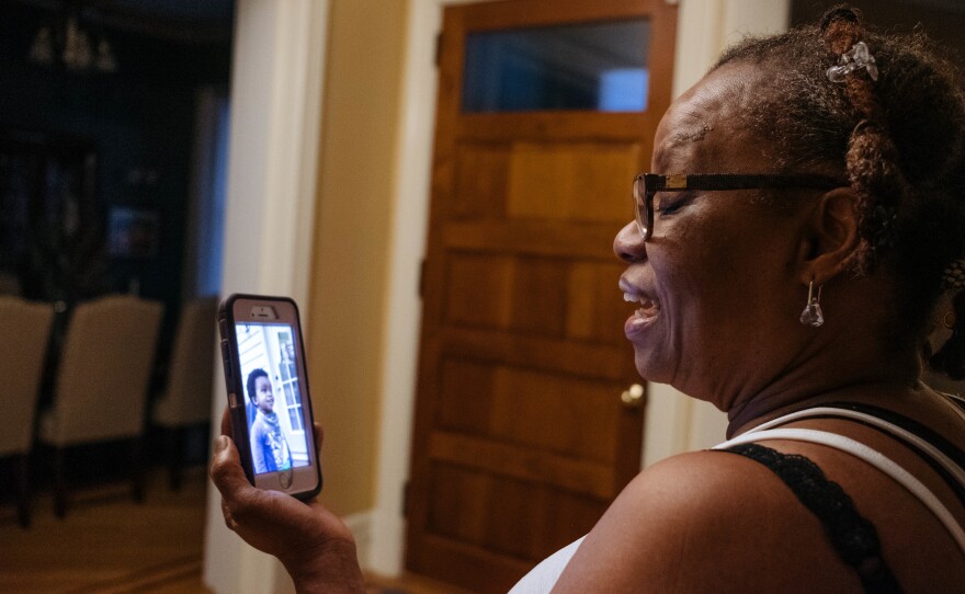 Raymonde Elian talks with her grandson by video call on her day off in May 2020.
