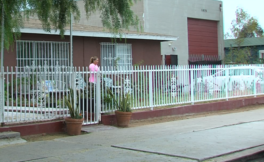 Alexia Ortega looks at the street from the front lawn of her home in Barrio Logan on Sept. 8, 2016.