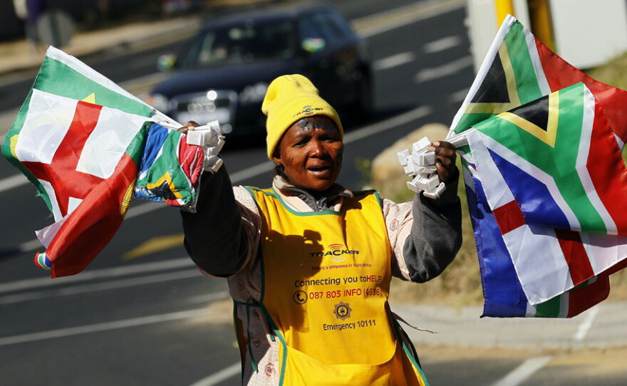 A woman sells national flags to drivers in the streets of northern Johannesburg on Sunday.
