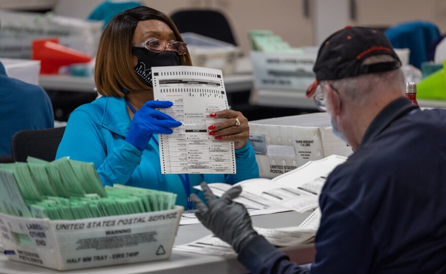 Election workers sort ballots at the Maricopa County Ballot Tabulation Center last week in Phoenix. The election is not considered over until the vote totals are reviewed and certified.