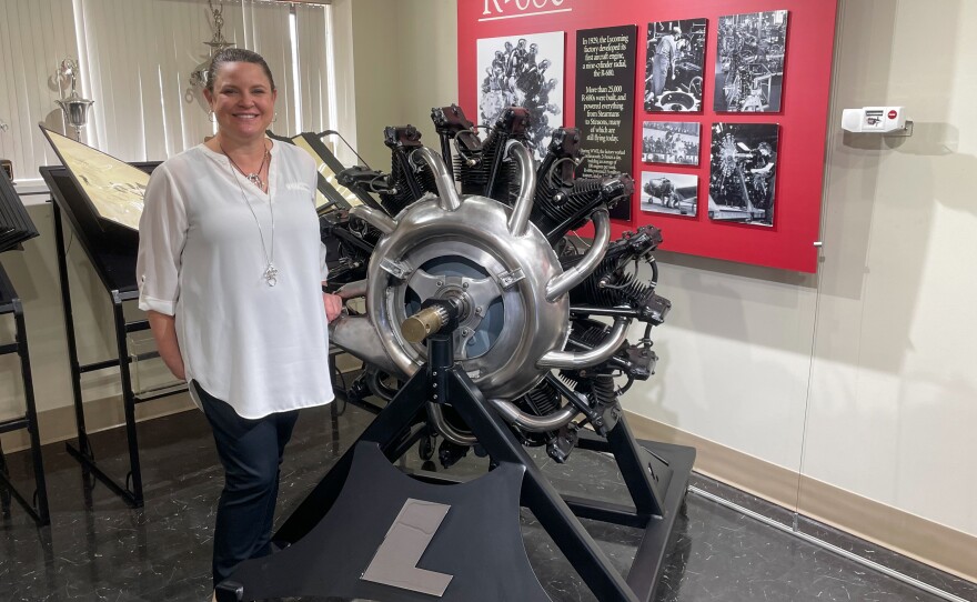 Shannon Massey, senior vice president at Lycoming Engines, next to an antique aircraft engine at the company's Williamsport factory.