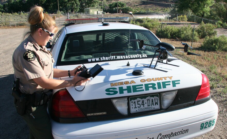 Deputy Amanda Hill of the Mesa County Sheriff's Office in western Colorado prepares to use a Draganflyer X6 drone equipped with a video camera to help search for a suspect in a knife attack in this undated photo.