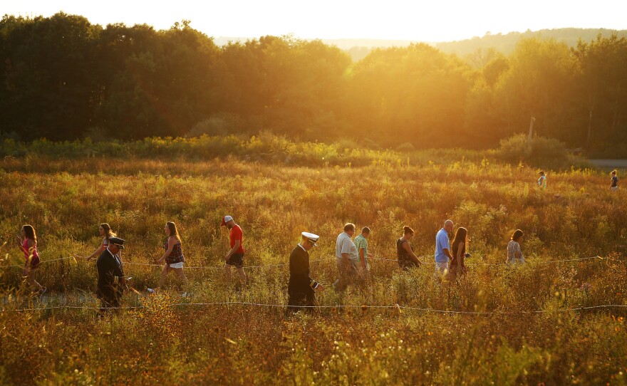 Visitors make their way through the Flight 93 National Memorial before lit candles are carried to the Wall of Names in memory of the passengers and crew of Flight 93, at the Flight 93 National Memorial in Shanksville, Pa.