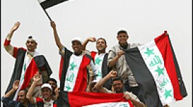 Iraqi supporters of Shiite cleric Muqtada al-Sadr carry their national flags as they arrive at Najaf.