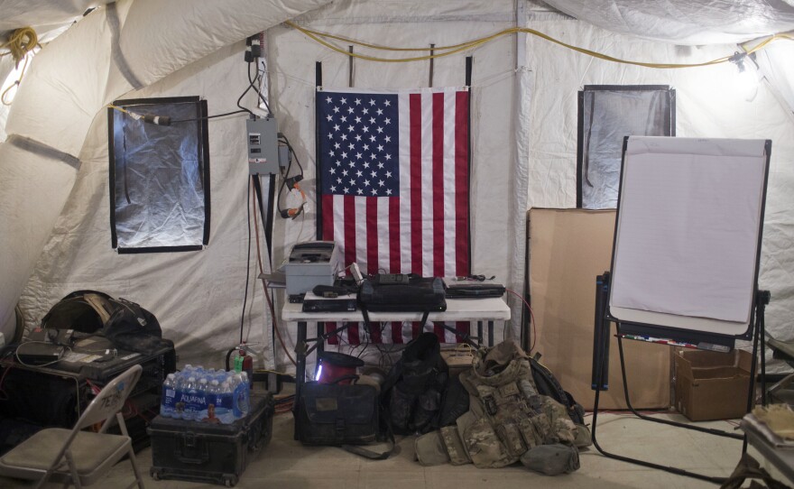 A U.S. flag hangs on the wall of a Qayara command and control center at a coalition air base about 30 miles south of Mosul, Iraq.