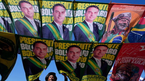 A street vendor sells campaign flags of presidential candidates Sen. Flavio Bolsonaro and current President Luiz Inacio Lula da Silva who is running for reelection in Brasilia, Brazil, Tuesday, Sept. 29, 2026.