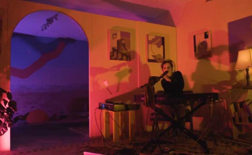 A still from the video performance segment of Good Faith Gallery's "In Here/Out There" exhibition. It features musician Salami Rose Joe Louis and visual art by Jonny Alexander.