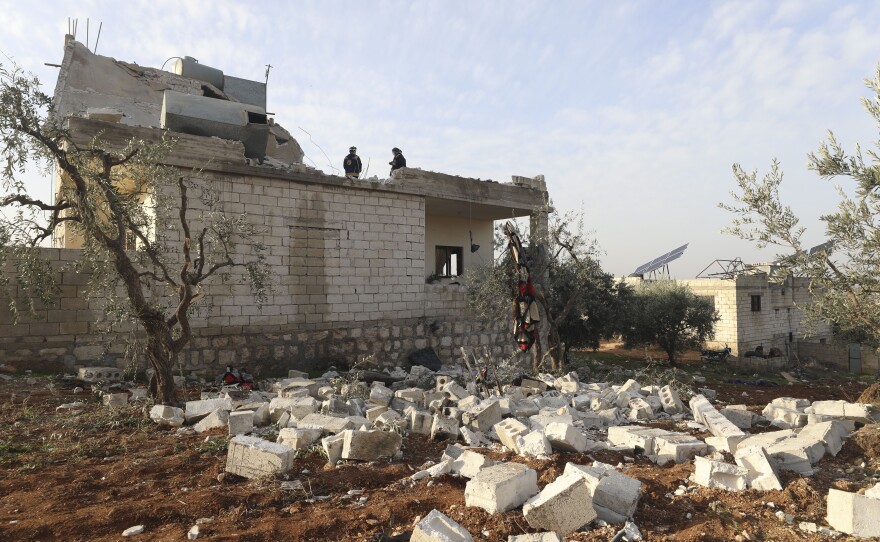 People check a destroyed house after a U.S. military operation in the Syrian village of Atmeh, in Idlib province, on Thursday. U.S. special forces carried out what the Pentagon said was a successful, large-scale counterterrorism raid. Local residents and activists said civilians were also among the dead.
