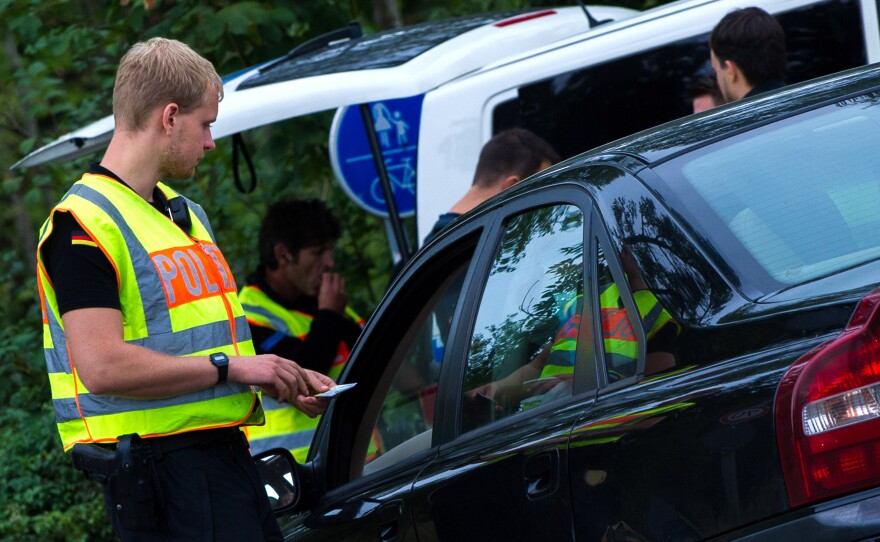 German police officers check vehicles on the border between Austria and Germany near Salzburg, Austria.