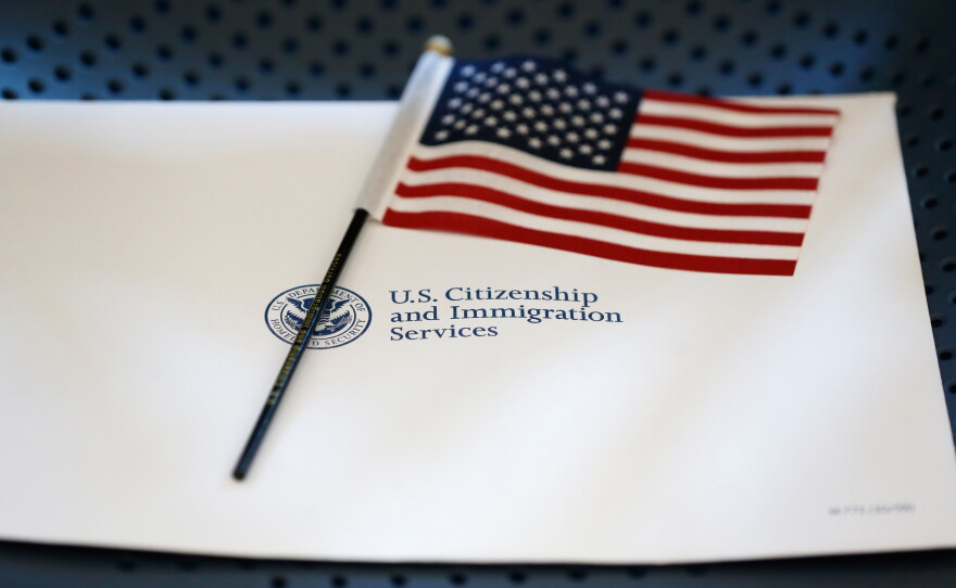 An information packet and an American flag are placed on a chair at the U.S. Citizenship and Immigration Services Miami Field Office on Aug. 17, 2018, in Miami.