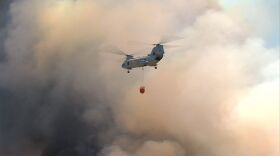 Military helicopter drops water on Cocos Fire