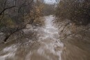 The Carmel River flows heavily after recent rains in Carmel Valley, Calif., Monday, Jan. 9, 2023.