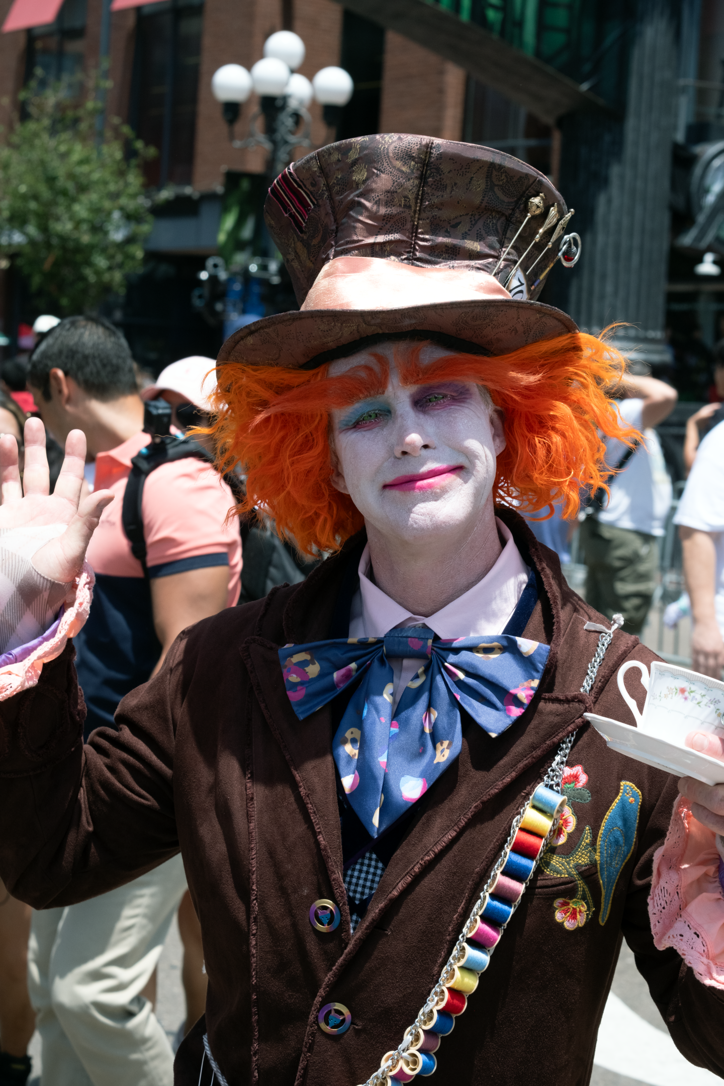 A cosplayer dressed as the Mad Hatter smiles for a portrait outside the San Diego Convention Center during Comic-Con on July 24, 2026.