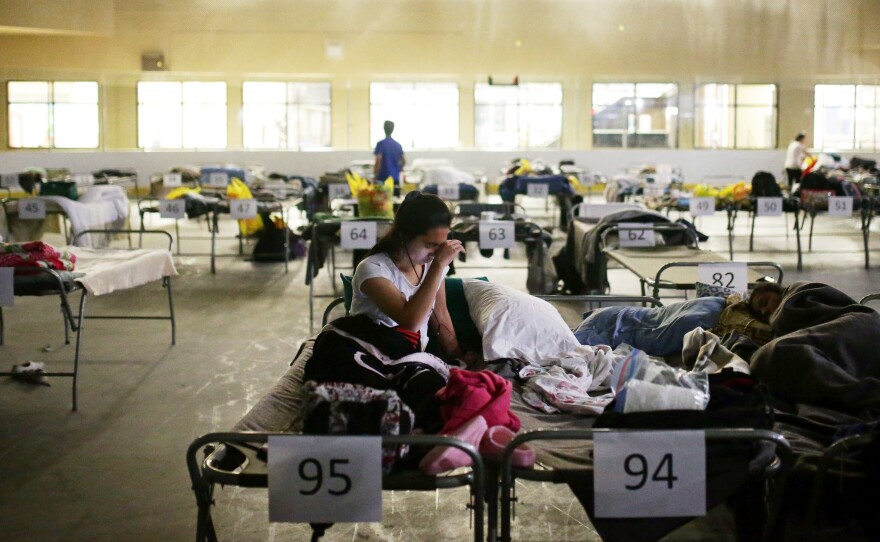 Tyra Abo sits on a cot at a makeshift evacuee center in Lac la Biche on Thursday.