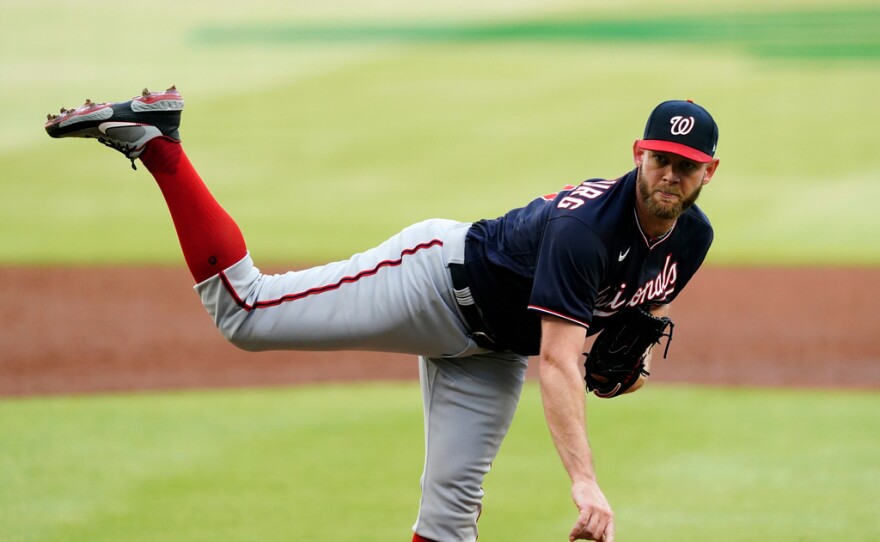 Former Washington Nationals starting pitcher Stephen Strasburg follows through on a pitch in the first inning of a baseball game against the Atlanta Braves, June 1, 2021, in Atlanta.