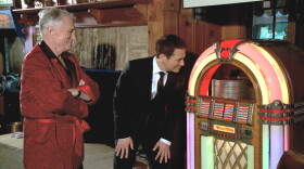 Michael Feinstein (right) inspects a vintage jukebox owned by Hugh Hefner (left).