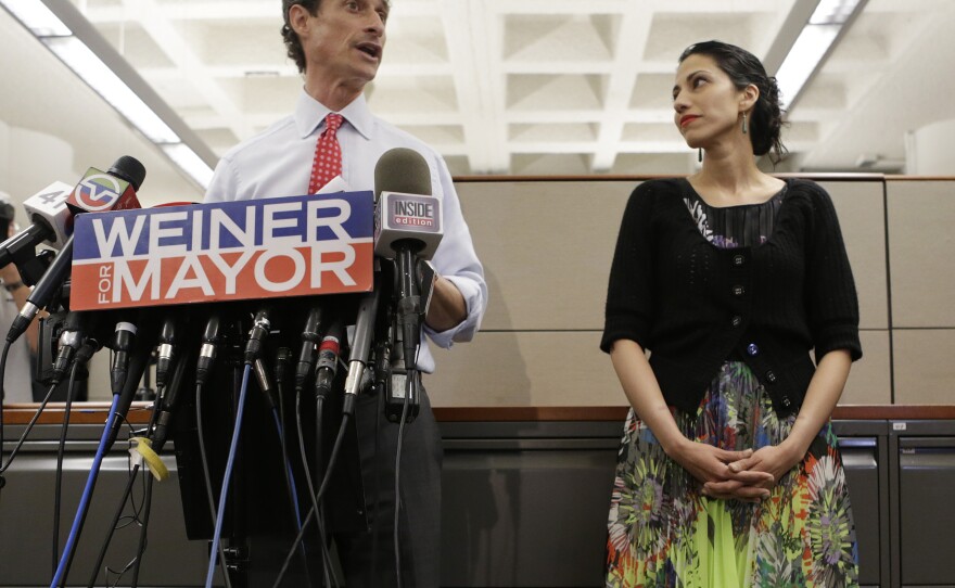 Huma Abedin (right) glances at her husband, New York City mayoral candidate Anthony Weiner, as he speaks at a press conference Tuesday.