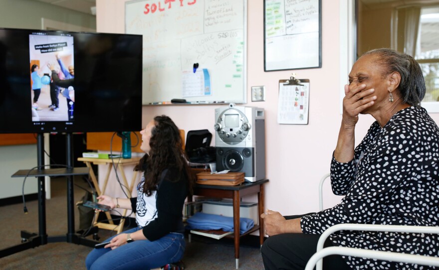 Ann Betts (right) reacts to a TikTok video that Amanda Bulgarelli (left) plays for her.