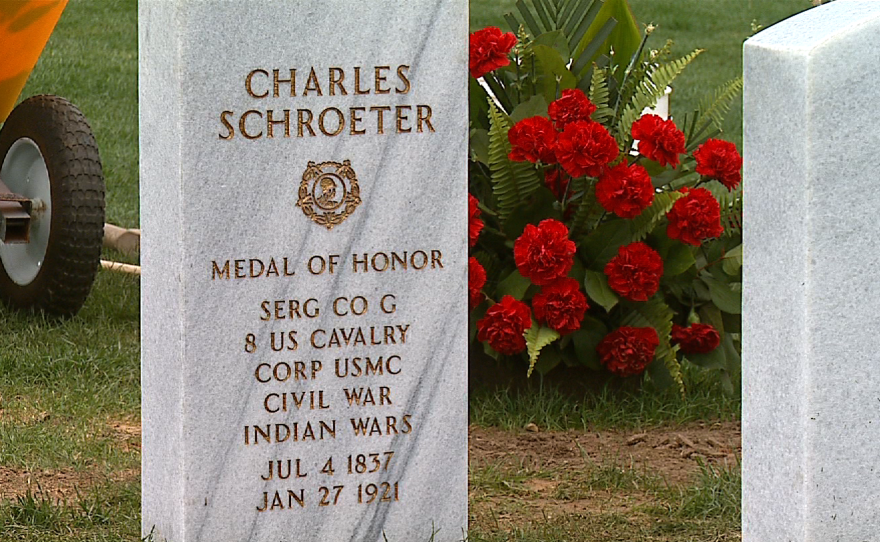 Sgt. Charles Schroeter's white marble gravestone is marked in gold inscription with the Medal of Honor insignia.