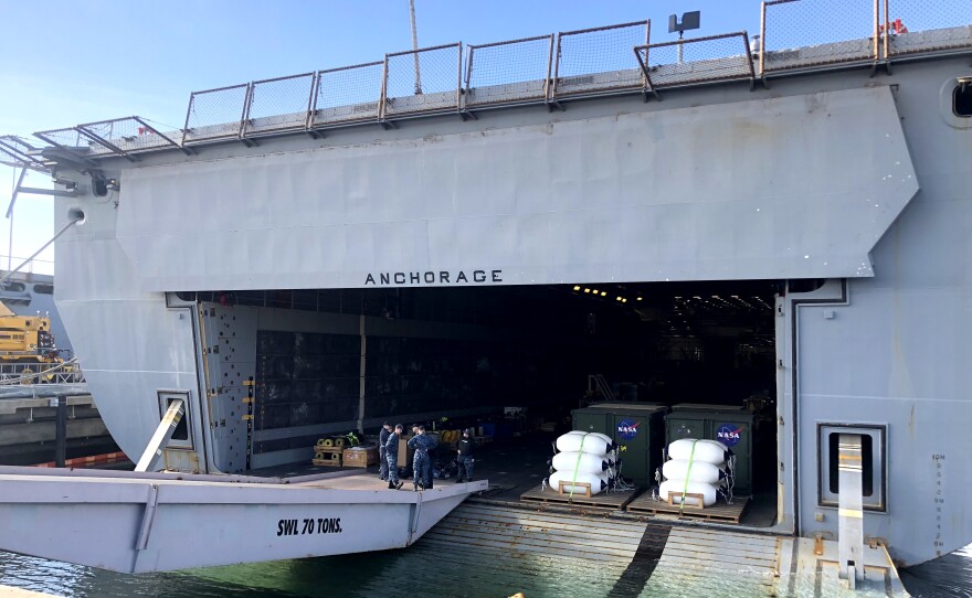 The test capsule is loaded onto USS Anchorage's (LPD 23) well deck during recovery, Jan. 25, 2018.