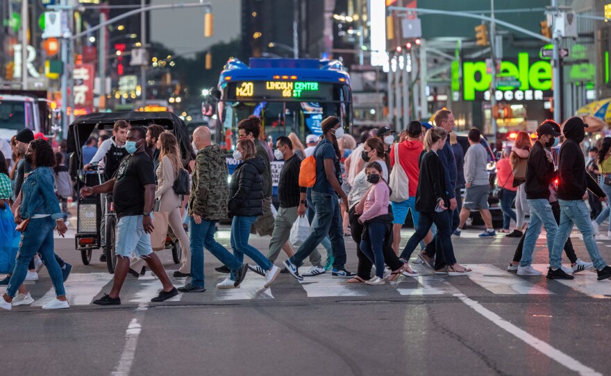 Crowds move through Times Square in New York City in June.