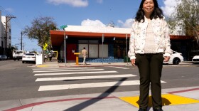 June Wong stands in front of what used to be "Lucky's Golden Phenix Restaurant" in North Park on Thursday, April 3, 2025. The street sign behind her will soon be changed to "Lucky Lane."