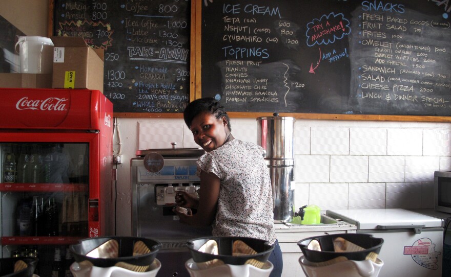 Manager Louise Ingabire fills an order for Belgian chocolate/banana swirl. "We were the first women drummers in Rwanda, and now we're the first to bring ice cream," she says. "We would like to change the culture."