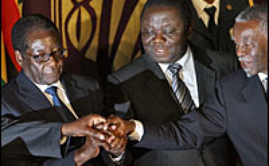 Zimbabwe's President Robert Mugabe (from left), opposition leader Morgan Tsvangirai and South African leader Thabo Mbeki agreed on a power-sharing deal on Sept. 15.