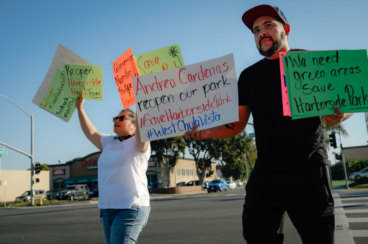 Organizer Leticia Lares, left, and another Chula Vista resident march in support of reopening Harborside Park in Chula Vista on Nov. 4, 2023.