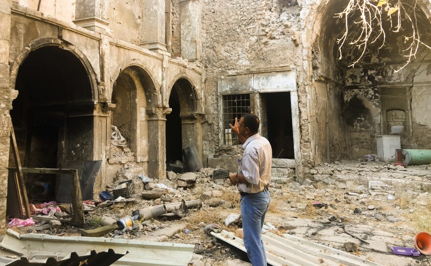 A Mosul resident looks at the ruins of a damaged historic house in his neighborhood in Mosul's Old City. The United Nations estimates 8,000 homes were damaged or destroyed in the fighting to take back this section of Iraq's second-biggest city.
