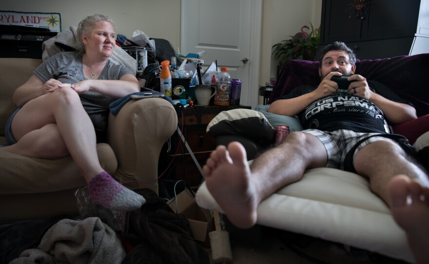 Michael Marquette plays video games while chatting with his wife, Jenn, as he heals from recent hip surgery.
