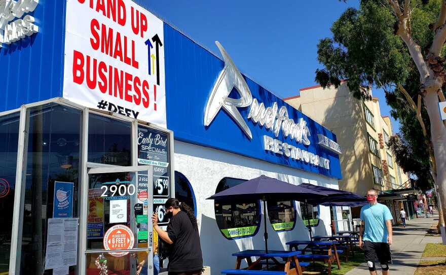 A sign hung on the exterior of Rudford's Restaurant reads "Stand Up Small Business! #Defy" in the North Park neighborhood of San Diego County. Sept. 20, 2020. 