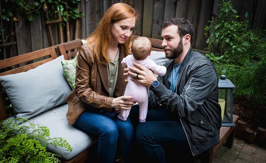 New parents, Erin and Gary Levin, gently play with their new-born daughter, Elizabeth, in their San Jose backyard. A gestational surrogate carried Elizabeth through birth. She is also the result of a mosaic embryo.