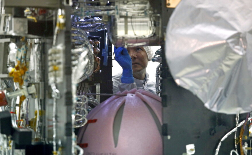 A worker looks inside the Parker Solar Probe in a clean room at Goddard in 2018.