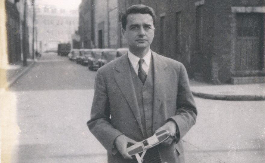 Edwin Land on street holding Land Camera test photo.
