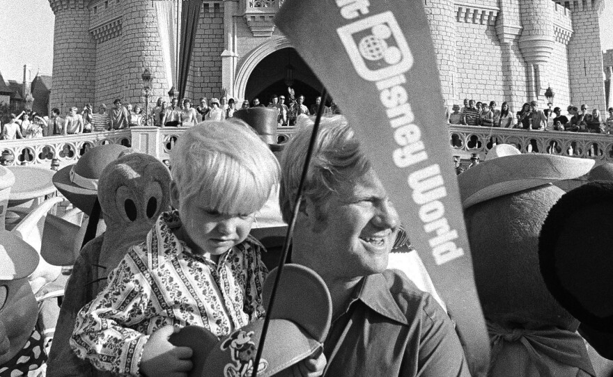 When Disney World opened on Oct. 1, 1971, tickets for adults were just $3.50. Here, William Windsor Jr. carries his son Lee, past Cinderella's castle on opening day.