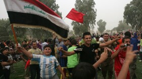 Iraqis wave Iraqi flags and dance as they celebrate the U.S withdrawal from Iraqi cities on June 30, 2009 in Baghdad, Iraq. 
