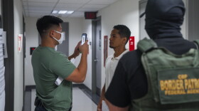 A federal immigration agent uses facial recognition software to confirm an asylum seeker's identity prior to an immigration hearing on July 30, 2025, in New York. In addition, DHS is expanding its use of iris scanners to help quickly identify undocumented immigrants.