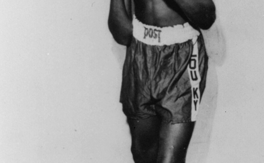 An 85-pound Cassius Marcellus Clay Jr. is shown posing at 12 years old, prior to his amateur ring debut in 1954. He won a gold medal in the light-heavyweight division at the 1960 Summer Olympic Games in Rome as a member of the U.S. Olympic boxing team.