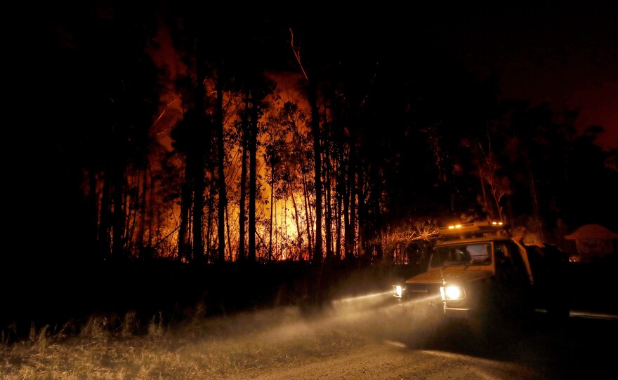 Fire response crews monitor the blazes Thursday in East Gippsland, Australia, where deadly bushfires have destroyed properties and prompted warnings from local authorities.