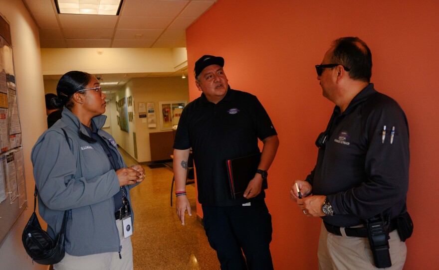 National City HOME team caseworkers Qiana Williamson, left, and Hector Hueso, right, talk with a city code enforcement officer at City Hall in National City, California on March 7, 2024. National City is the second in San Diego County to move away from a police-led response to homelessness and toward trained caseworkers.