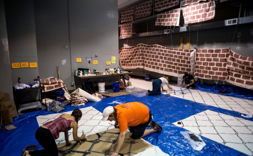 Volunteers with Mijente, a national "Latinx and Chicanx" organizing group, paint a "wall" ahead of Wednesday's "Wall Off Trump" protest. Mijente worked with several other organizations to orchestrate the protest, including the Georgia Latino Alliance for Human Rights, Ruckus Society and Other98.