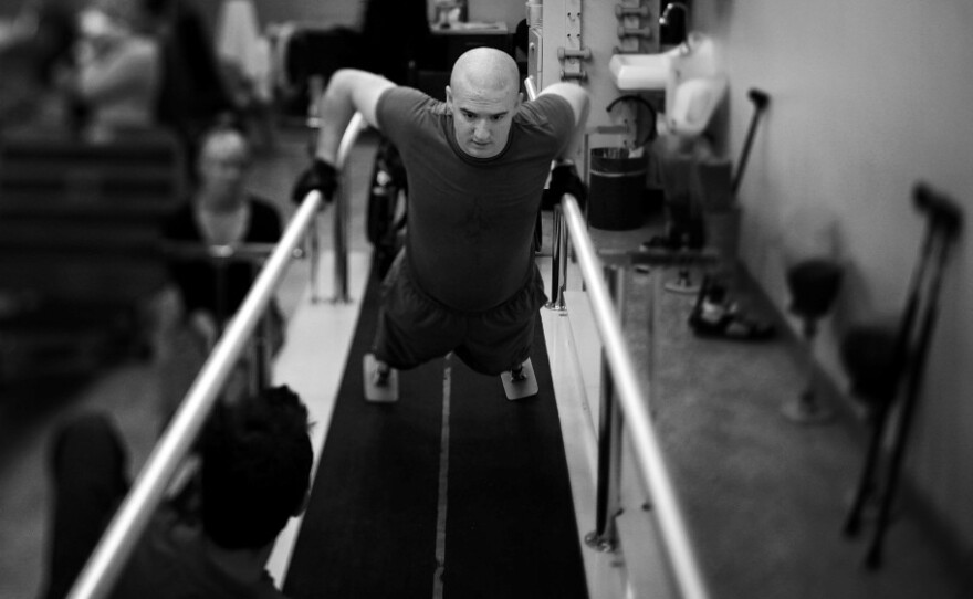 Lance Cpl. Jake Romo does physical therapy at the Naval Medical Center in San Diego, Calif. He lost both legs in an explosion in Sangin, Afghanistan, in February 2011, while serving with the 3/5 Marines.