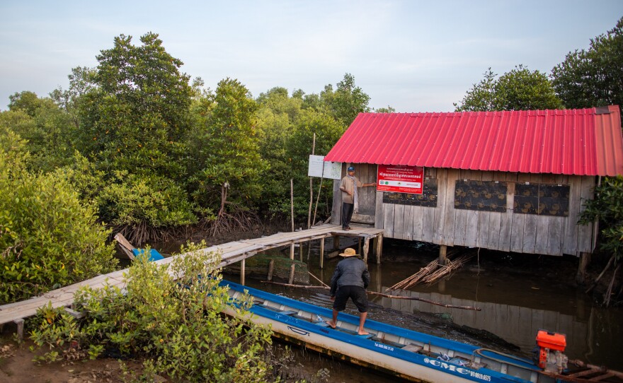 Khiev Sat and his son Khiev Chien ready a boat at a building managed by the Koh Kresna Lok Community Fishery in Cambodia.