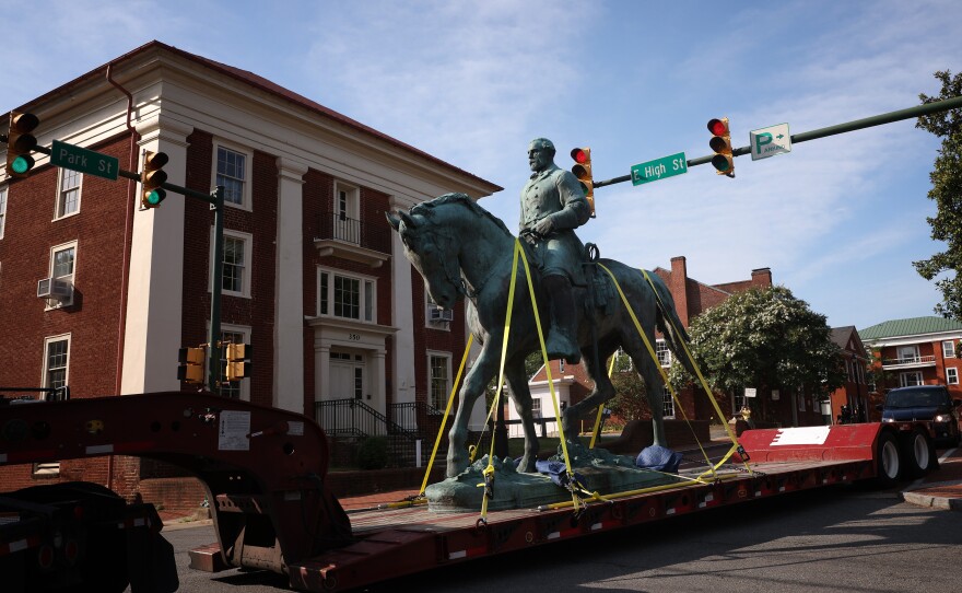 A flatbed truck carries a statue of Confederate Gen. Robert E. Lee from the Market Street Park July 10, 2021 in Charlottesville, Va. Initial plans to remove the statue sparked the infamous "Unite the Right" rally where Heather Heyer was killed, two state troopers died, and dozens of people were injured.