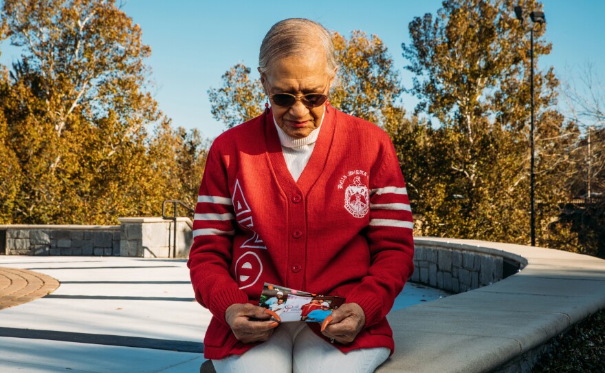 Marian Hatch, a former resident at Arbor Terrace at Cascade, looks at one of the photos of her friends. Hatch, 92, tested positive for the coronavirus but survived and was one of Ernestine Mann's closest friends at the facility.