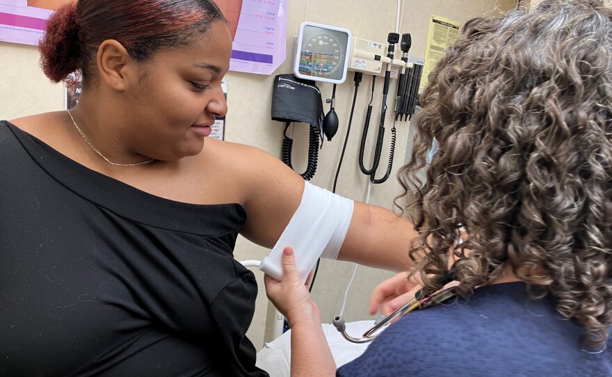 Nurse practitioner Arin Kramer bandages I'laysia Vital's arm after inserting a contraceptive implant that will last up to five years.