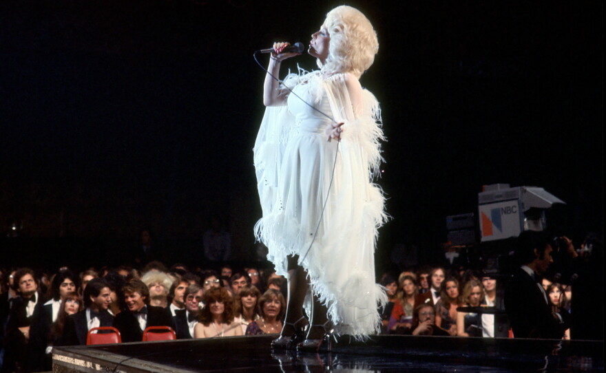 Country singer Dolly Parton performs onstage, circa 1977.