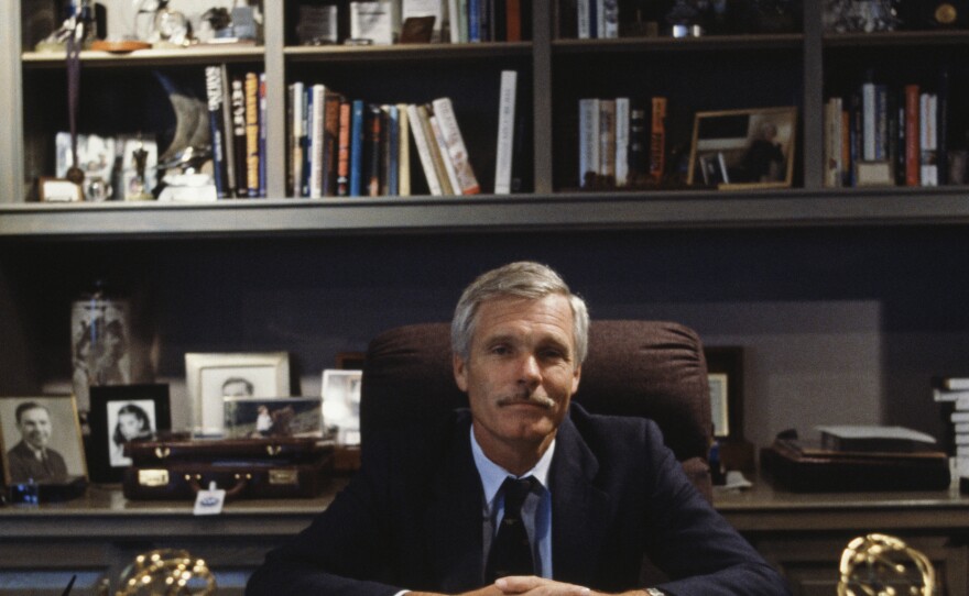 Ted Turner sits in his office in October 1986. "He was a visionary, a trailblazer, a rabble-rouser, a do-gooder," says former CNN chief news executive Eason Jordan.