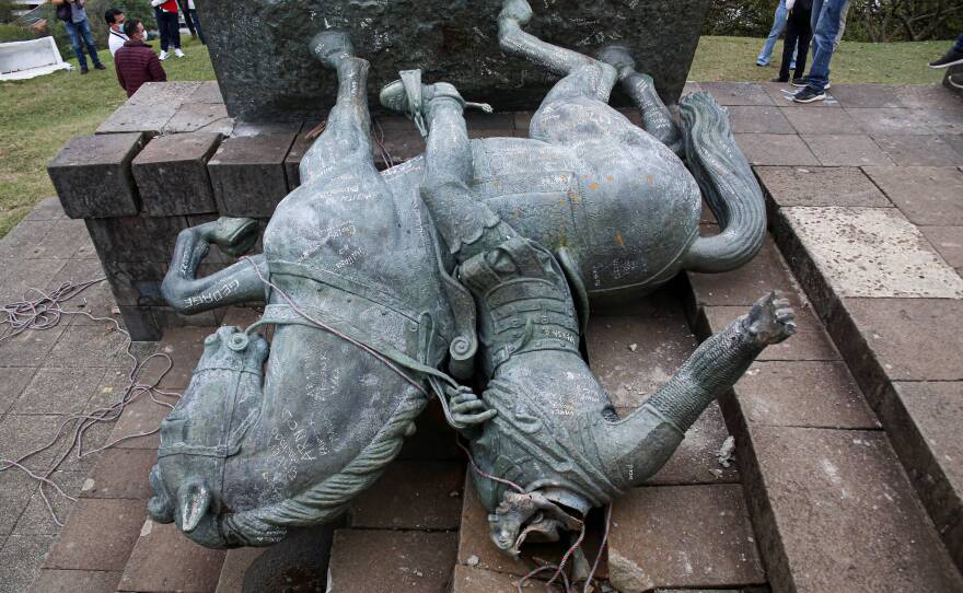 The statue of Sebastián de Belalcázar, a 16th century Spanish conquistador, lies on the ground after it was pulled down by Indigenous people in Popayán, Colombia, on Sept. 16.